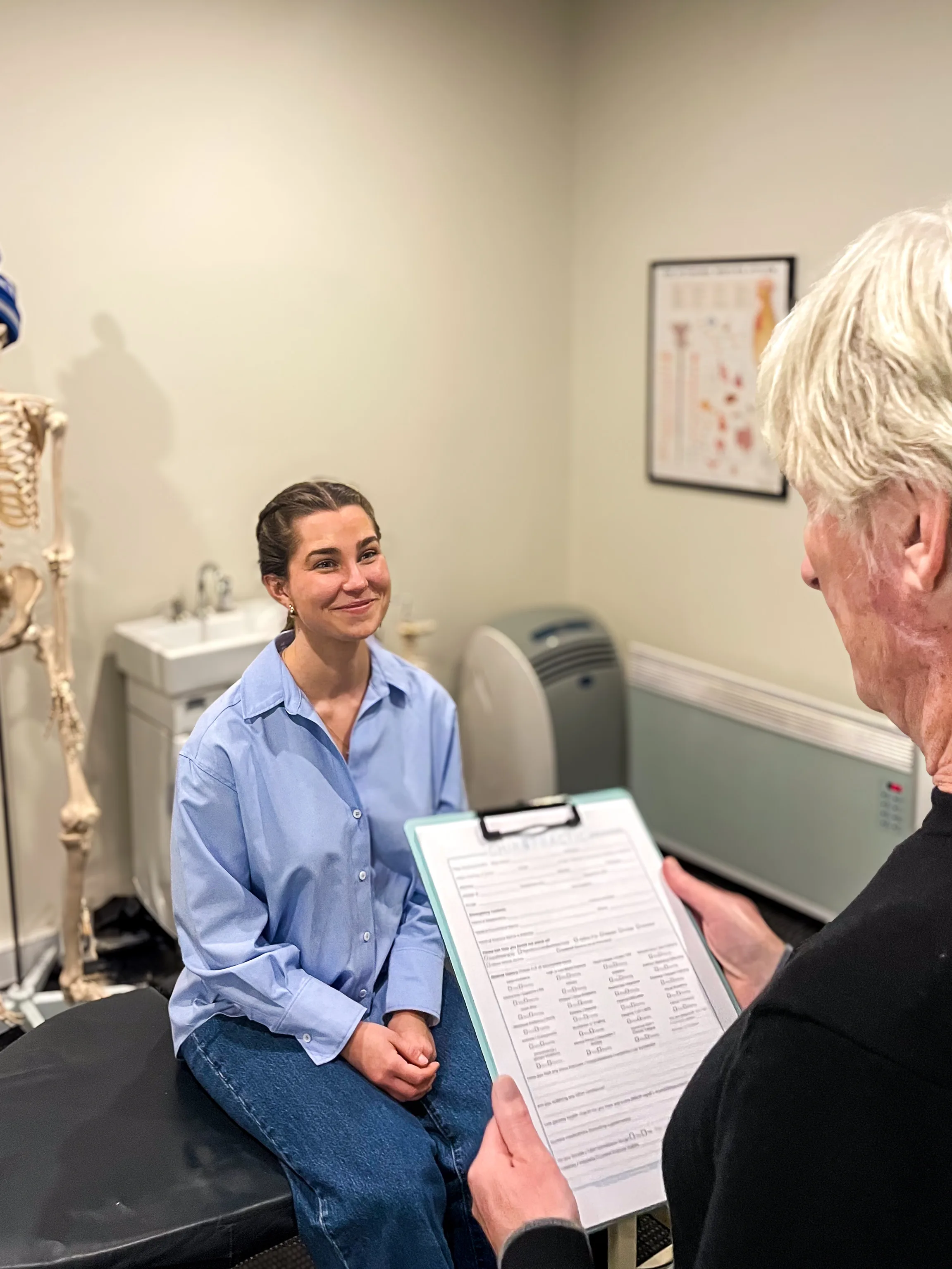 Practitioner taking a case history from a patient in the consulting room